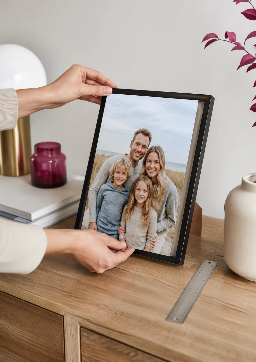 A4 family photo print being placed into a standard picture frame