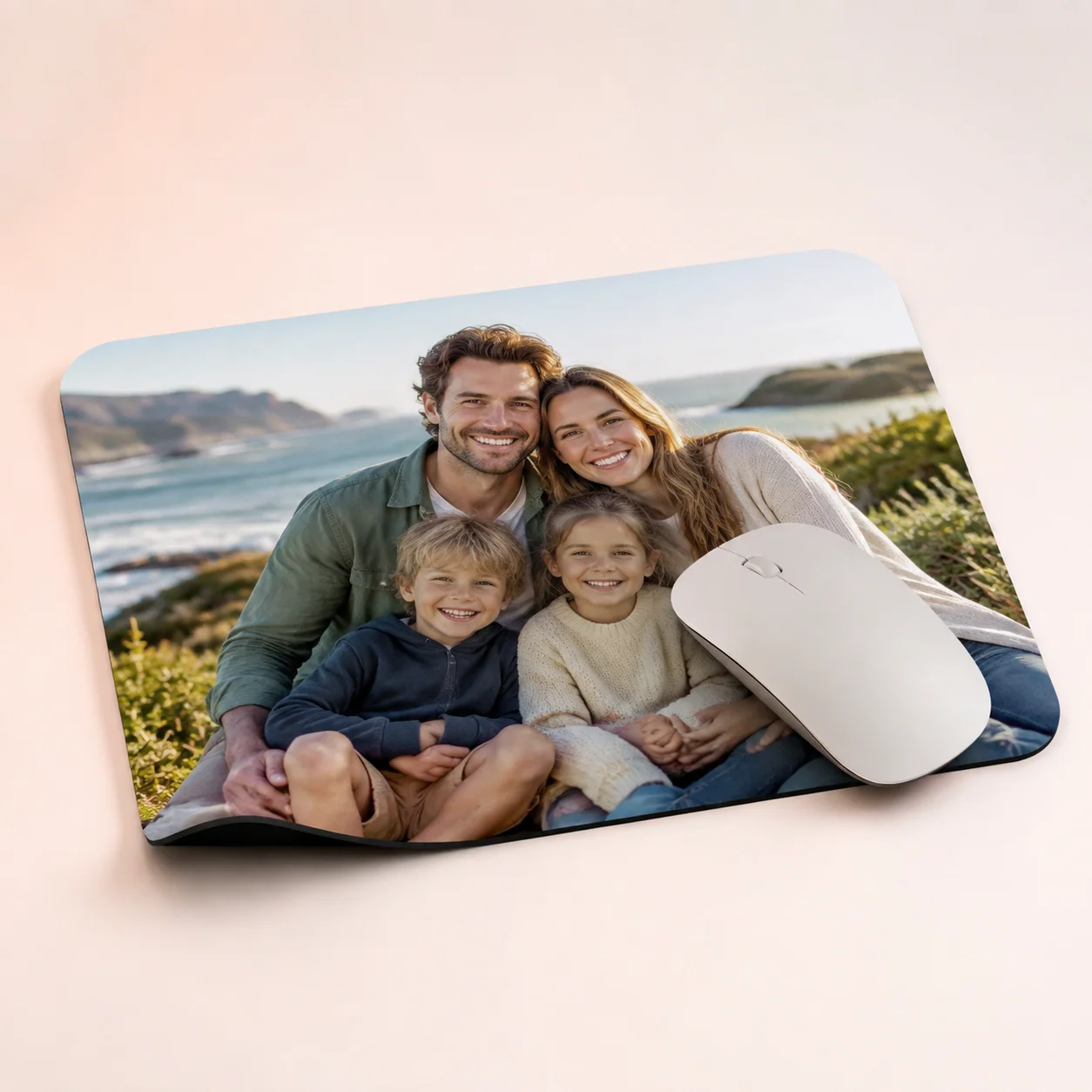 Family photo mouse mat on a desk beside a white computer mouse